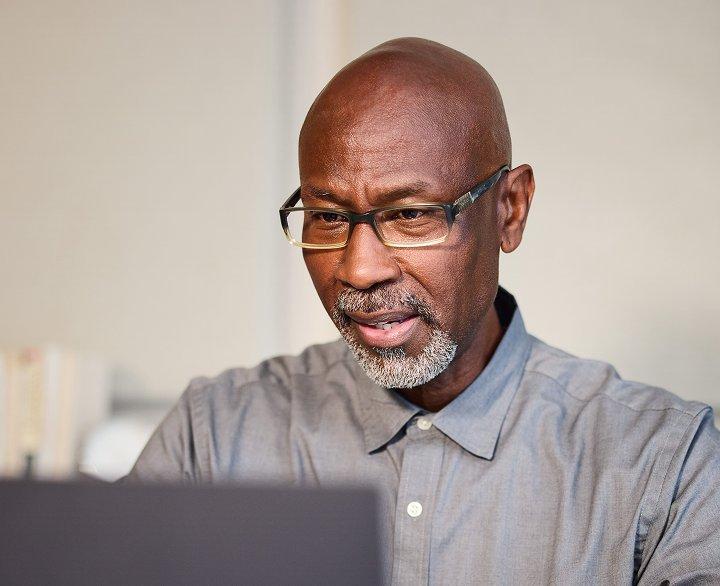 Dexcom CGM user looking at a laptop